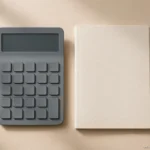 How to Compare the Total Cost of an Online Master's Degree calculator and notebook on a desk